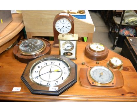 A circular cased barometer, another barometer and various clocks