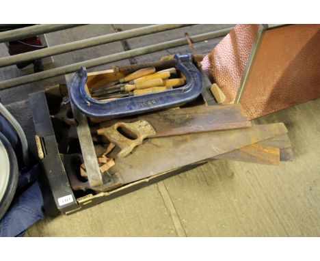A box of tools including saws, large G-clamp, chisels etc