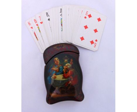 A late 19th century continental papier mache playing card holder to include a pack of playing cards