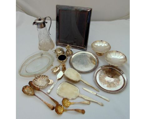 A quantity of silver plate to include a cut glass claret jug with silver plated collar and handle, a photograph frame, a dres