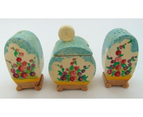 Clarice Cliff pottery three piece condiment set decorated with flowers and leaves circa 1930, 7cm (h) marks to the base