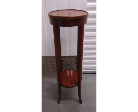 An early 20th century mahogany circular plant stand on four tapering outswept legs, 100 x32.5cm