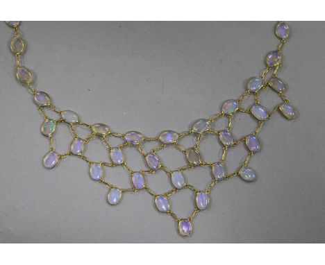 A 14ct gold and white opal fring necklace, 42cm.