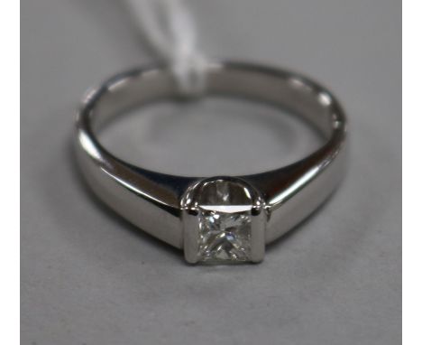 An 18ct white gold and princess cut solitaire diamond ring, size K.