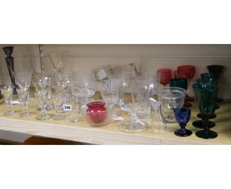 A collection of 19th century glassware including firing glasses, coloured wines and a ladle