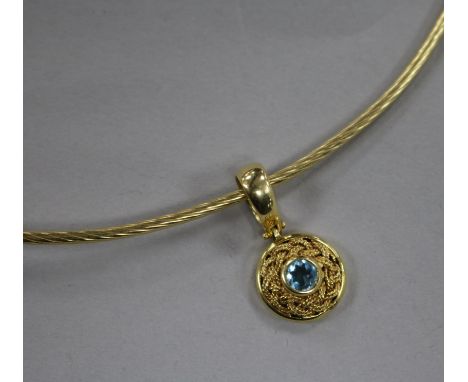 A 14ct gold and blue topaz pendant on a 14ct gold necklet.
