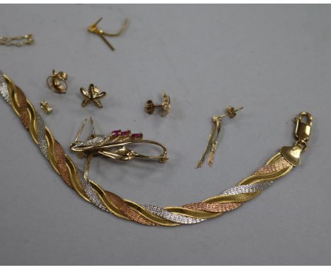 A 9ct three-colour gold bracelet, a 9ct gold and ruby openwork spray brooch, a 9ct gold chain and sundries