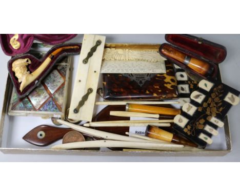 A collection of curios including a meerschaum pipe and two card cases