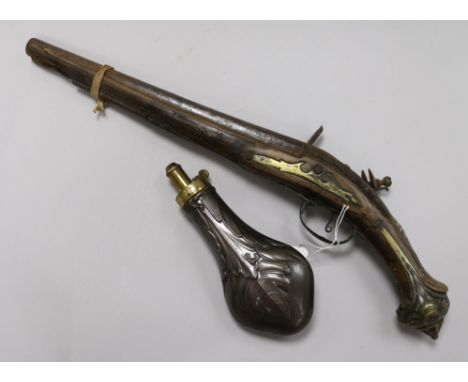 A late 18th century Turkish flintlock pistol and a copper powder flask 48cm. & 20cm.