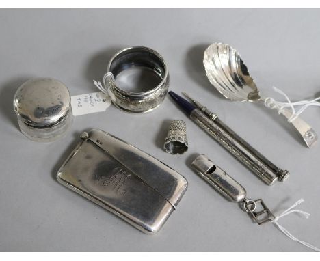 Eight assorted small silver items including a Georgian Scottish caddy spoon, a card case and whistle.