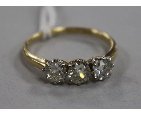 An 18ct gold and three stone diamond ring, size R.