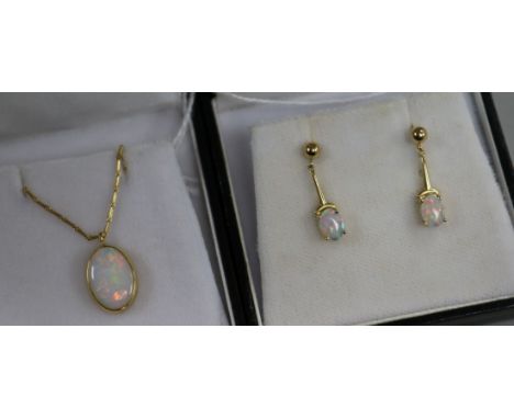 An 18ct gold and opal pendant on chain and a similar pair of opal and 14ct gold earrings.