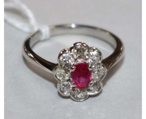 A white gold, ruby and diamond oval cluster ring, size N.