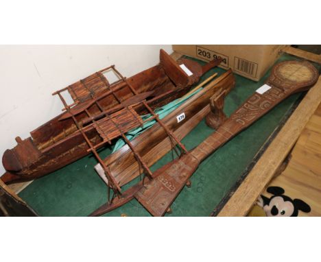 Two wooden models of boats and a carved four string instrument largest boat 86cm