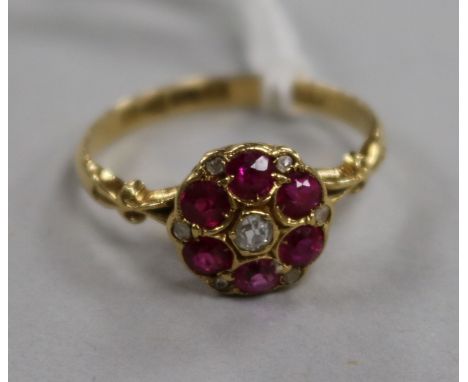 An early 20th century 18ct gold, ruby and diamond cluster flowerhead ring, Chester, 1916, size N.