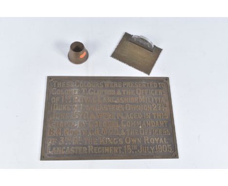 A BRASS MILITARY PLAQUE AND TWO SMALL PIECES OF TRENCH ART, the plaque would have been attached to a wall and it reads These 