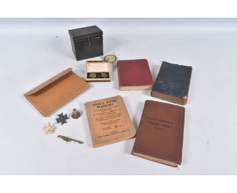 A SMALL COLLECTION OF MILITARIA FROM WWI AND LATER, to include a 1915 army stationary pack, a later small arms manual named t