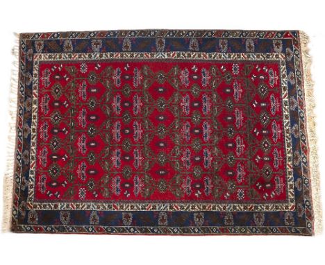 Large Turkish red ground carpet with rows of medallions within a blue border, 358cm x 257cm