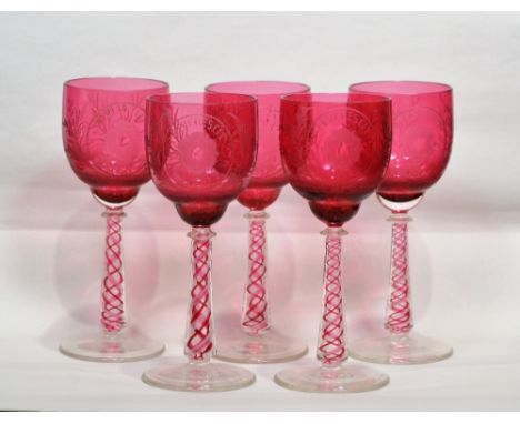 Set of five ruby coloured glass drinking glasses  20th Century, with ruby and clear glass air twist stems and engraved decora