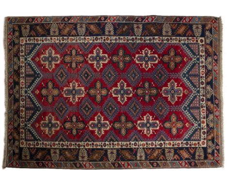 Turkish red ground carpet with three rows of star designs, 195cm x 289cm