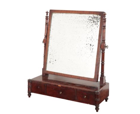 A REGENCY MAHOGANY DRESSING MIRRORthe rectangular plate held on ring turned supports, the base with three frieze drawers on s
