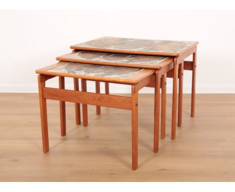 A NEST OF THREE TEAK TABLESmid 20th century, each with hand painted tile inset tops, the largest 46cm high x 62cm wide x 42cm