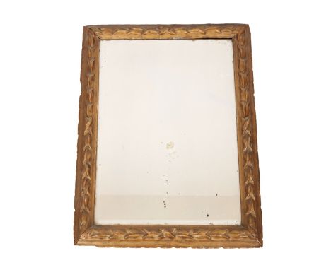 A CARVED GILTWOOD DRESSING MIRRORthe bevelled rectangular plate within a bell flower moulded surround, a stand to the reverse