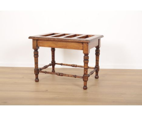 A STAINED WOOD LUGGAGE STANDlate 19th/early 20th century, on ring turned legs and conforming stretchers, 48cm high x 65cm wid