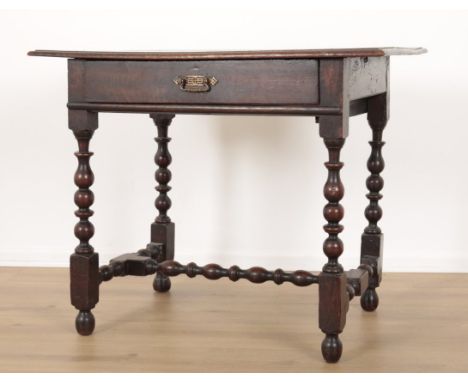 AN OAK SIDE TABLE18th century, with a single frieze drawer, on bobbin turned legs joined by a conforming stretcher, 72cm high
