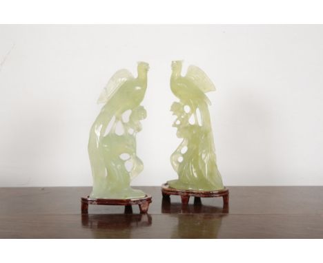 A PAIR OF CHINESE CARVED JADE BIRDS20th century, each figured naturalistically on tree stumps with flowers issuing, 18.5cm hi