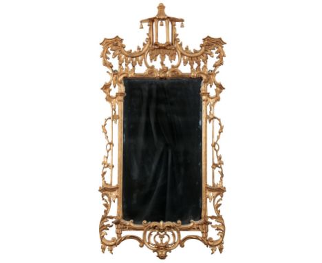 A GEORGE II STYLE GILTWOOD AND COMPOSITION MIRROR&nbsp;the rectangular plate within an ornately carved and pierced surround, 