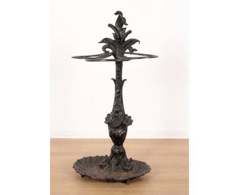 A VICTORIAN CAST IRON STICK STANDthe back piece decorated with wheat sheaves and flowers, with a shell shaped drip  pan, 75cm