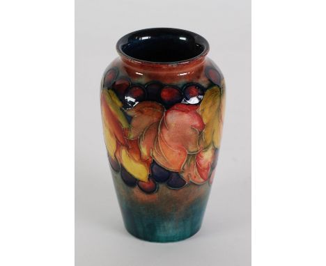 WILLIAM MOORCROFT 'LEAF AND BERRY' PATTERN TUBE LINED POTTERY VASE, of tapering high shouldered form, decorated in tones of r