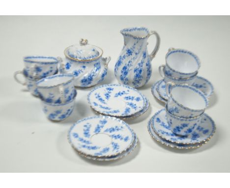 EIGHTEEN PIECE GERMAN BLUE AND WHITE PORCELAIN TEA SET FOR EIGHT PERSONS, wrythen handled and floral printed with gilt lined 