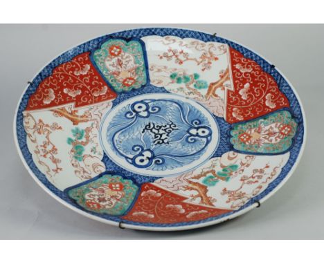 JAPANESE LATE MEIJI PERIOD IMARI PORCELAIN LARGE WALL PLAQUE, typical form, painted with a stylised central roundel enclosed 
