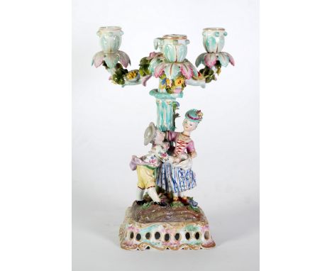 LATE NINETEENTH CENTURY GERMAN FLORAL ENCRUSTED PORCELAIN FIGURAL THREE BRANCH CANDELABRUM, painted in colours and gilt and m