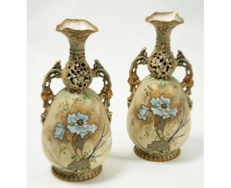 PAIR OF EARLY TWENTIETH CENTURY ERNST WAHLISS, AUSTRIAN BLUSH PORCELAIN TWO HANDLED VASES, each of footed baluster form with 