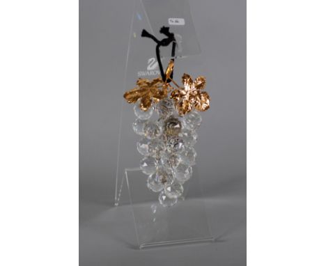 SWAROVSKI CUT GLASS AND GILT METAL MODEL OF A BUNCH OF TWENTY THREE GRAPES and two leaves, 6 1/2" (16.5cm) high and the persp