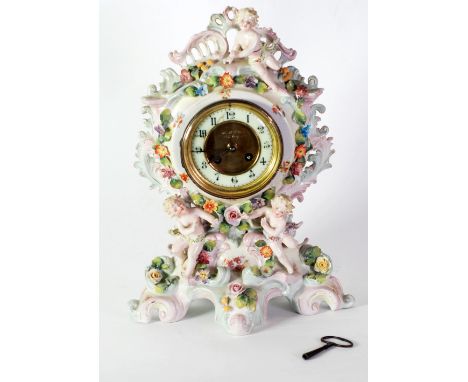 EARLY TWENTIETH CENTURY CONTINENTAL FLORAL ENCRUSTED PORCELAIN MANTEL CLOCK, the 5" Arabic dial with matted gilt centre, powe