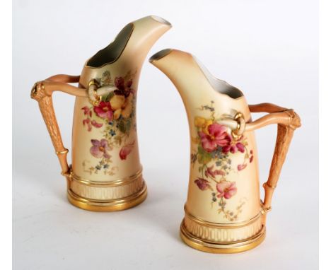PAIR OF EARLY TWENTIETH CENTURY ROYAL WORCESTER BLUSH CHINA TUSK SHAPED JUGS, with rustic handles and moulded bases, printed 