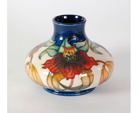 MODERN MOORCROFT 'ANNA LILY' PATTERN TUBE LINED POTTERY VASE, of squat footed form with short neck, decorated in tones of red