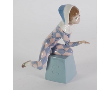 LLADRO PORCELAIN FIGURE  OF A HARLEQUIN, modelled kneeling on a square tapering stand, initialled 'C' with right hand outstre