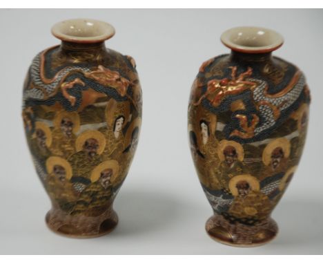 PAIR OF JAPANESE MEIJI PERIOD MOULDED SATSUMA POTTERY VASES, each of ovoid form with waisted neck, decorated with seated immo