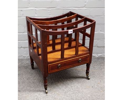 A late George III mahogany Canterbury, with two divisions and a boxwood strung frieze drawer, on ring turned legs and castors