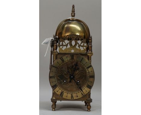 A 19th century brass lantern clock enclosing a French two train movement, 31cm high. (key) 