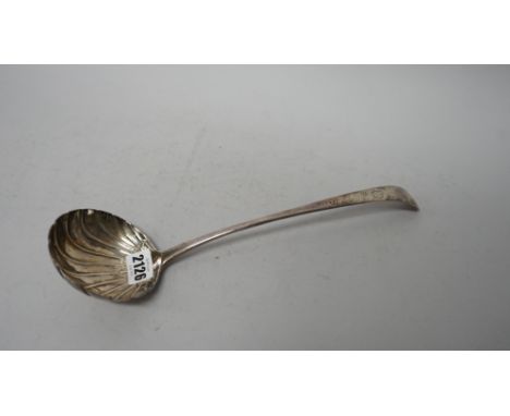 A George III Irish silver 18th century soup ladle, the bowl with partly fluted decoration, the handle with later floral decor