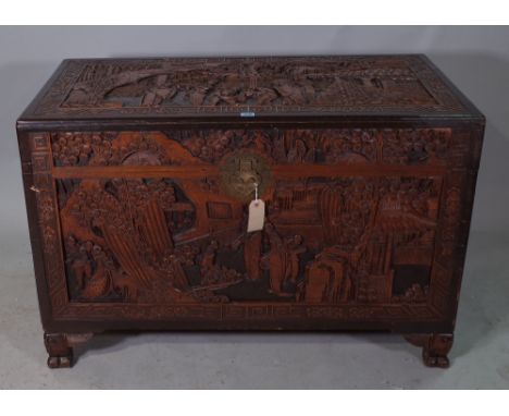 An early 20th century Chinese carved camphorwood trunk, on winged beast supports, 107cm wide x 70cm high.   35