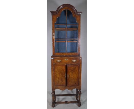 A Queen Anne mahogany arch top display cabinet with single drawer over cupboard doors on bun feet, 56cm wide x 198cm high. 