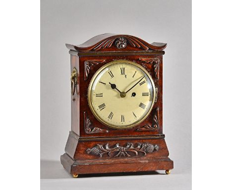 A Victorian mahogany cased mantel clock with shaped top and carved foliate embellishments, with painted tin dial and single t