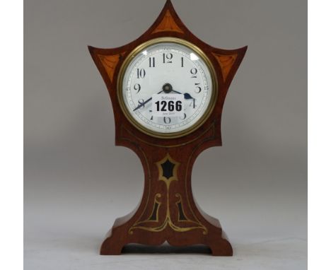 An Edwardian mahogany cased mantel clock with Art Nouveau style inlay and a shaped 'crown' enclosing a single train movement,